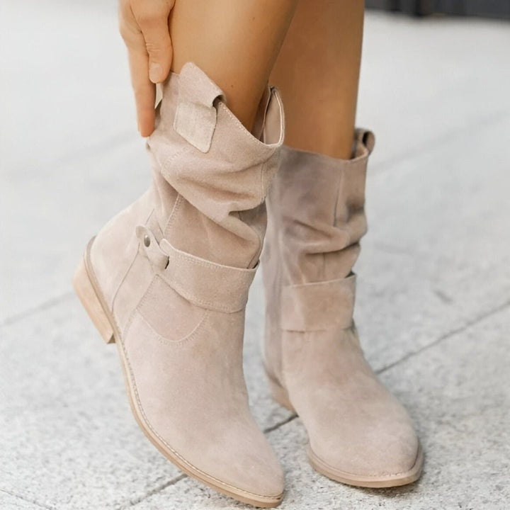 Women's winter slouchy ankle boots, offering warmth with a low heel and chic buckle accent.