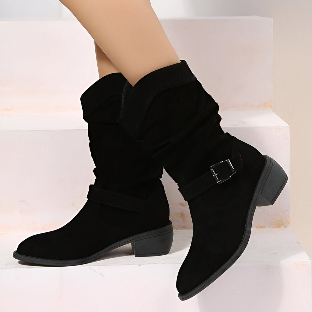 Fashionable women's slouchy ankle boots with a sturdy low heel and prominent buckle for fall.