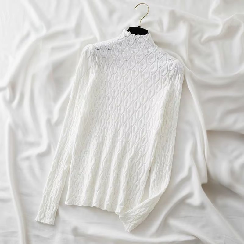 Woman models a stylish cashmere blend turtleneck sweater, ideal for elegant winter outfits.
