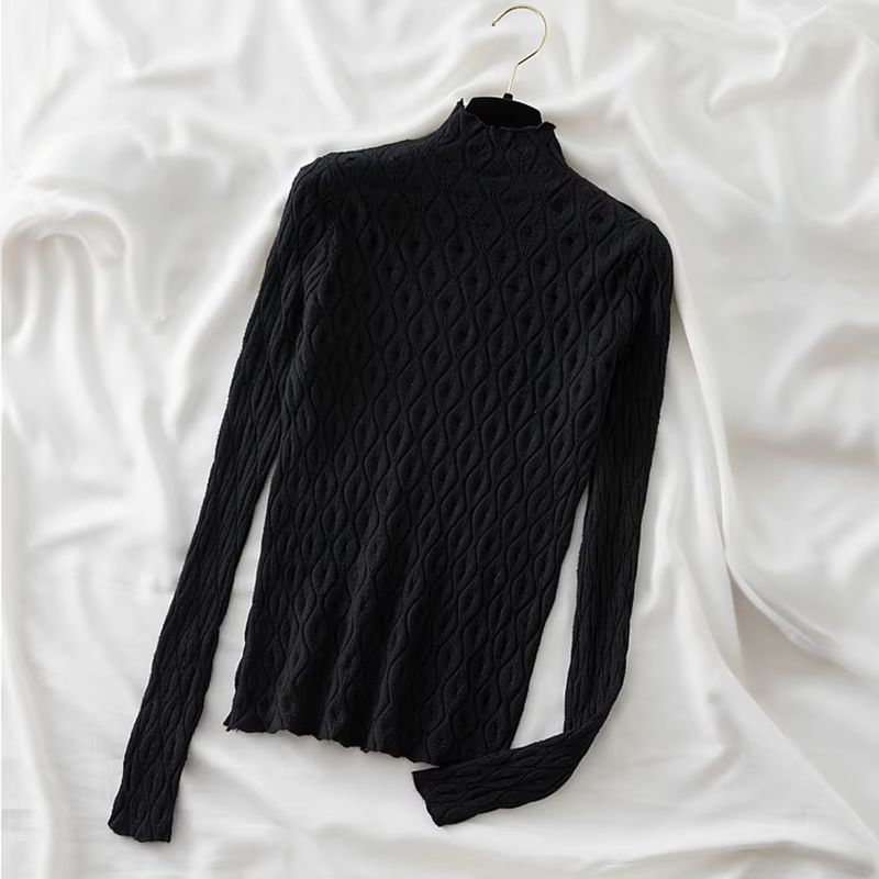 Close-up of a soft women's cashmere blend turtleneck sweater, highlighting knit texture and quality.