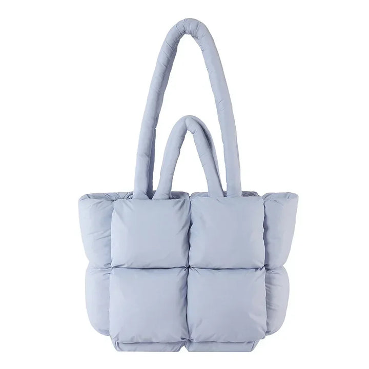 Fashionable women's puffer tote bag, chic padded design. Versatile shoulder handbag for a stylish look.