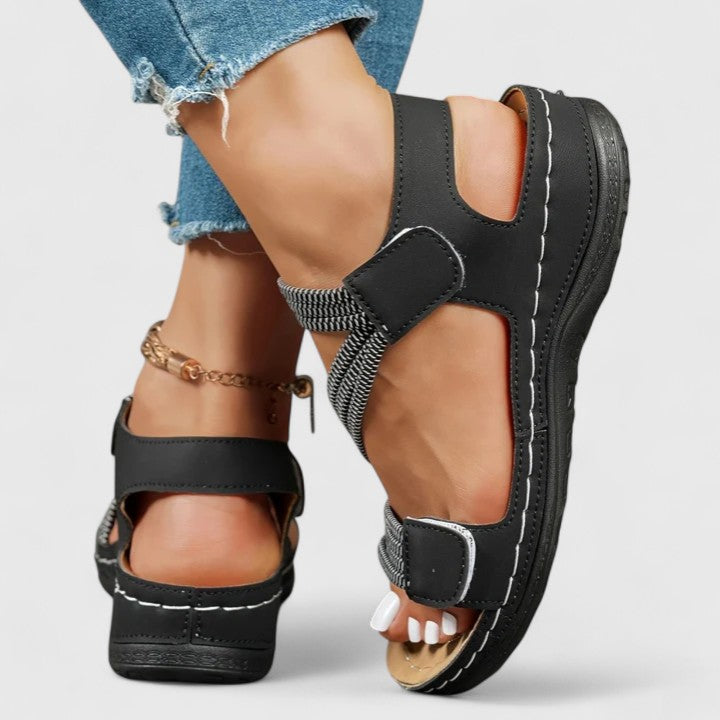Close-up of sophisticated women's sandals, showcasing quality design for arch support & comfort.