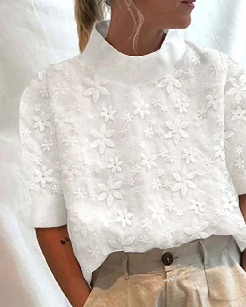Chic white women's blouse with an elegant stand collar & subtle floral details. A versatile, sophisticated top for any occasion.