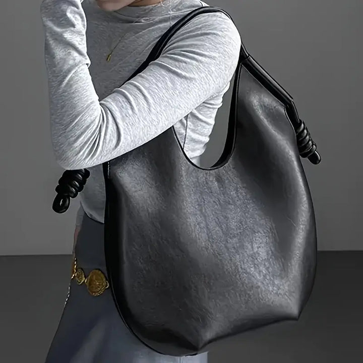 Spacious women's carryall tote, chic vegan leather bag for work, travel, or daily essentials.