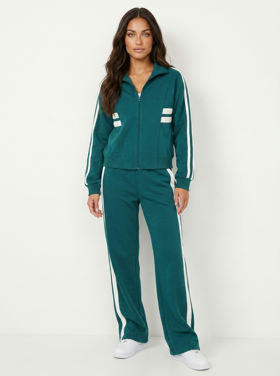 Sporty women's matching tracksuit set featuring contrast stripes, a zip-up jacket & wide leg pants.