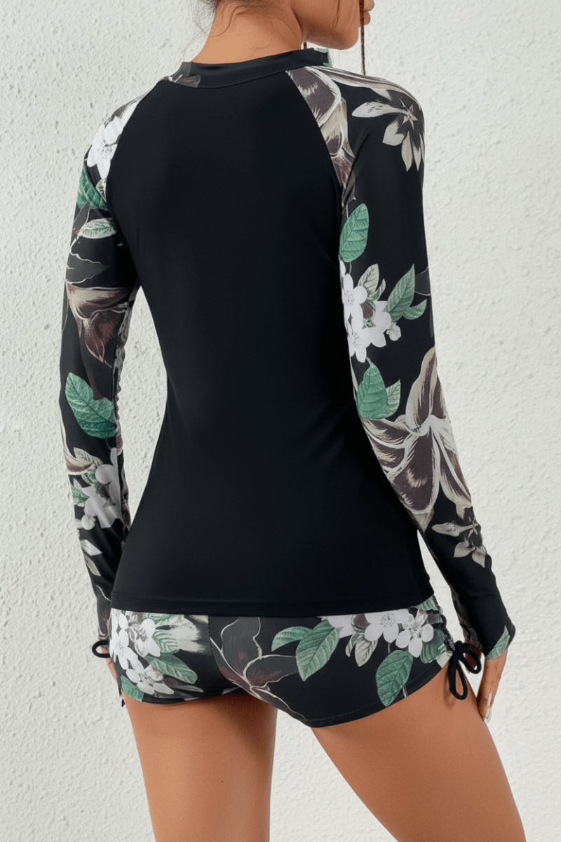 High-waisted tropical swim shorts, part of a sporty two-piece swimsuit for women's active beachwear.
