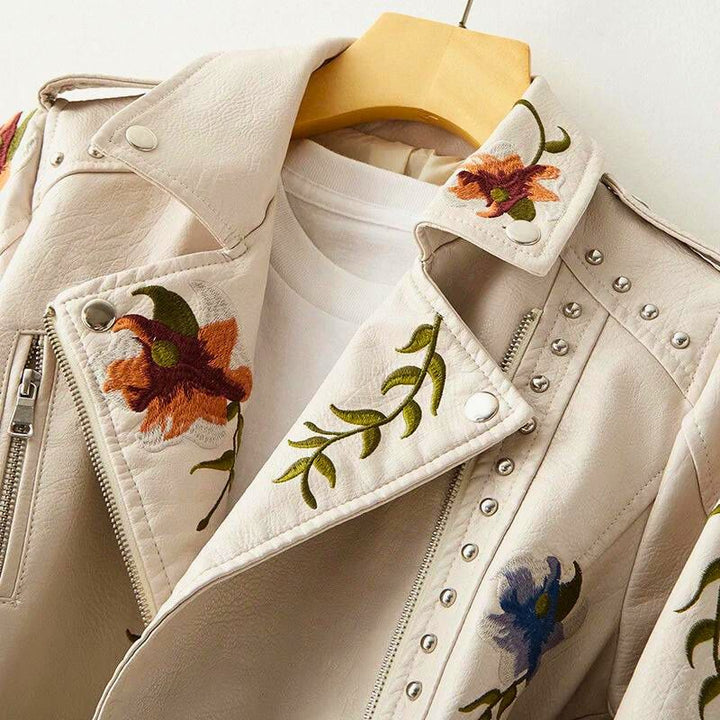 Distinctive women's statement jacket featuring beautiful floral embroidery & edgy stud embellishments for unique outerwear.