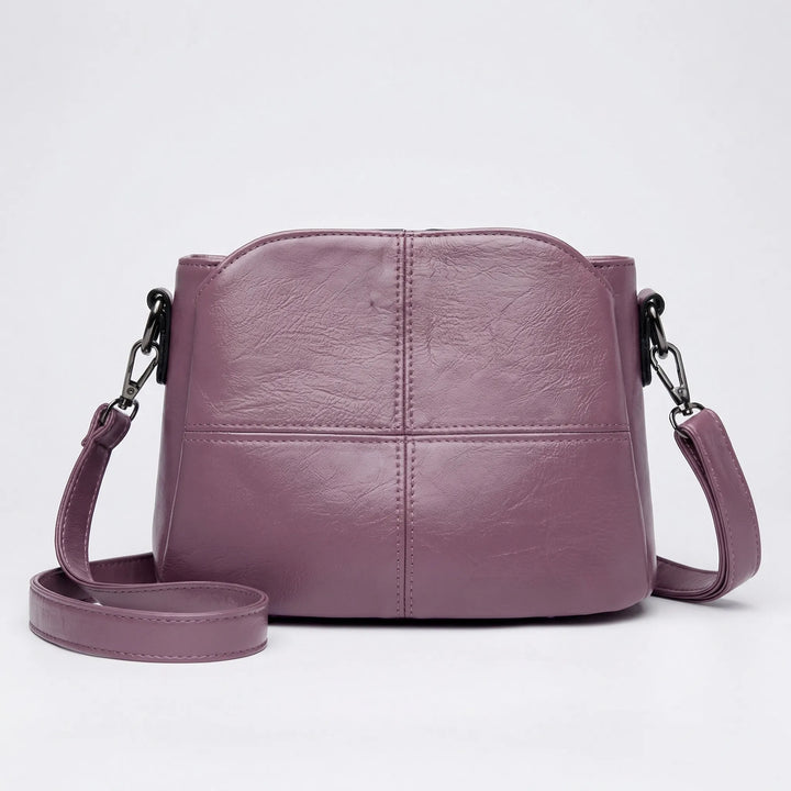 Designer style women's mini crossbody bag with unique stitched panels. A versatile shoulder handbag for daily use.