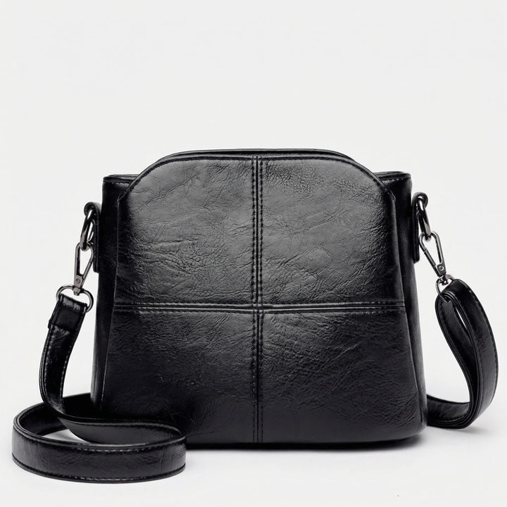 Fashionable women's shoulder bag, a compact crossbody with elegant stitched design. Ideal day or evening accessory.