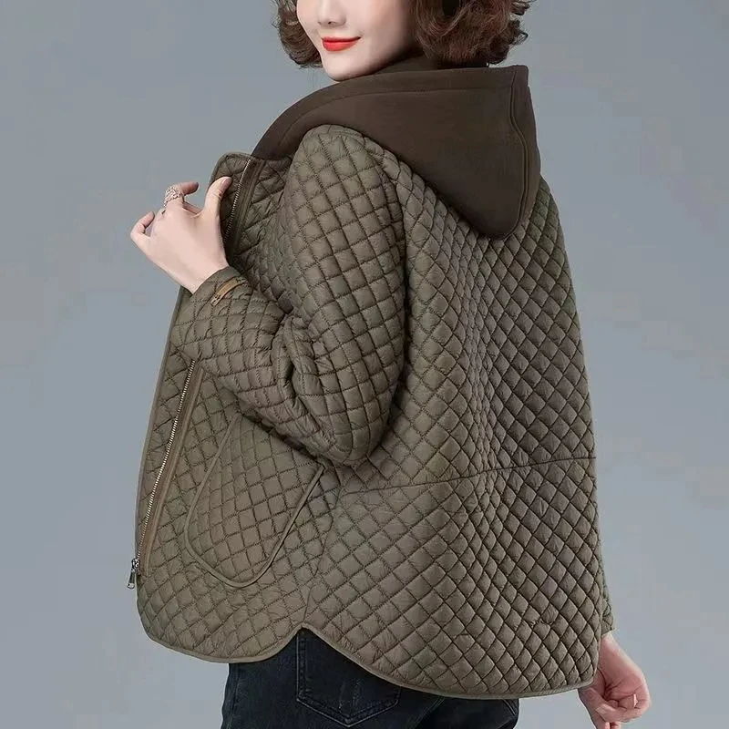 Women's stylish diamond-quilted jacket with asymmetrical hem and side zip, perfect for transitional weather.