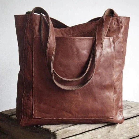 Front view of a women's stylish crossbody bag, showcasing its elegant design and organized pockets. Ideal for daily use.