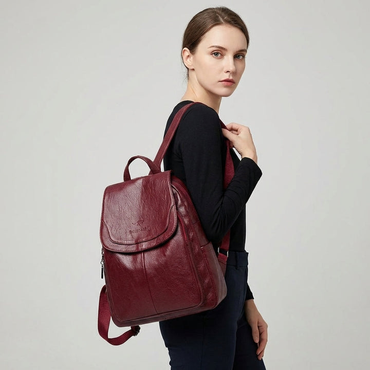 Elegant women's flap backpack, a versatile daily bag with secure closure & adjustable shoulder straps.