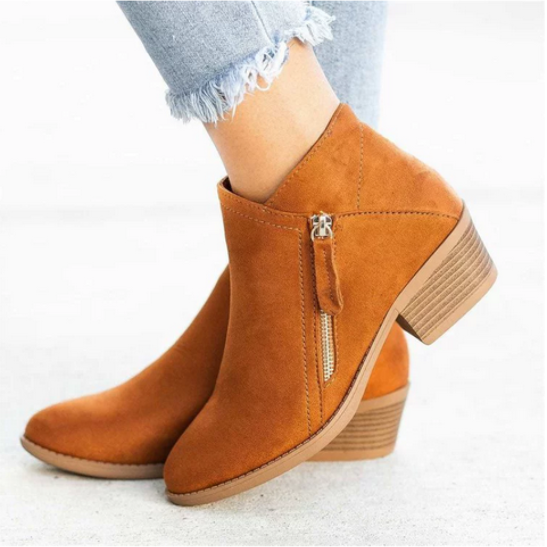 Women's stylish waterproof boots paired with jeans, showcasing versatile and comfortable everyday footwear.