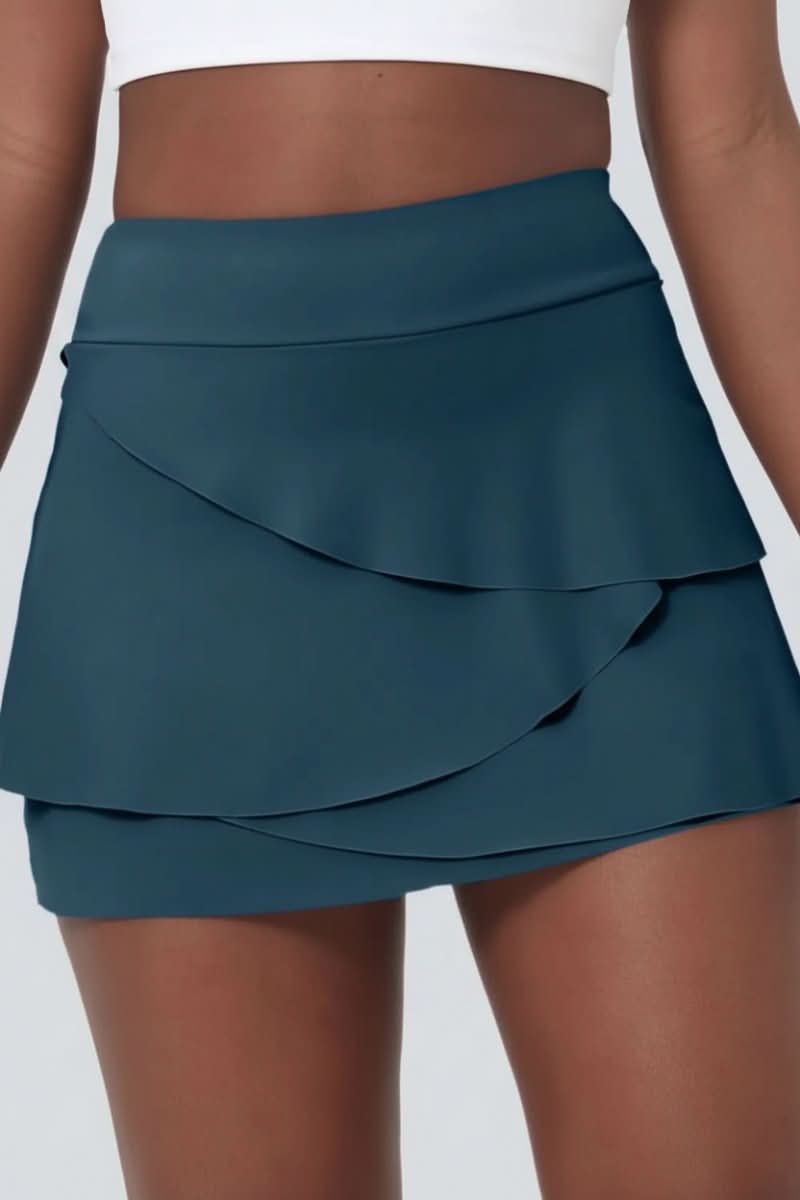 Women's golf skort featuring a tiered design, built-in shorts, and convenient pockets for performance & style.