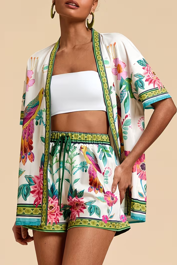 Casual women's matching short sleeve top and shorts set with a colorful tropical floral print for summer.