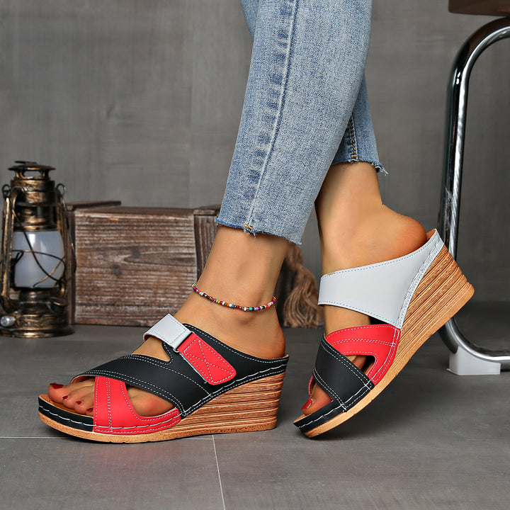 Detail shot of two-tone wedge women's slides. Open-toe summer sandals, highlighting the comfortable sole.