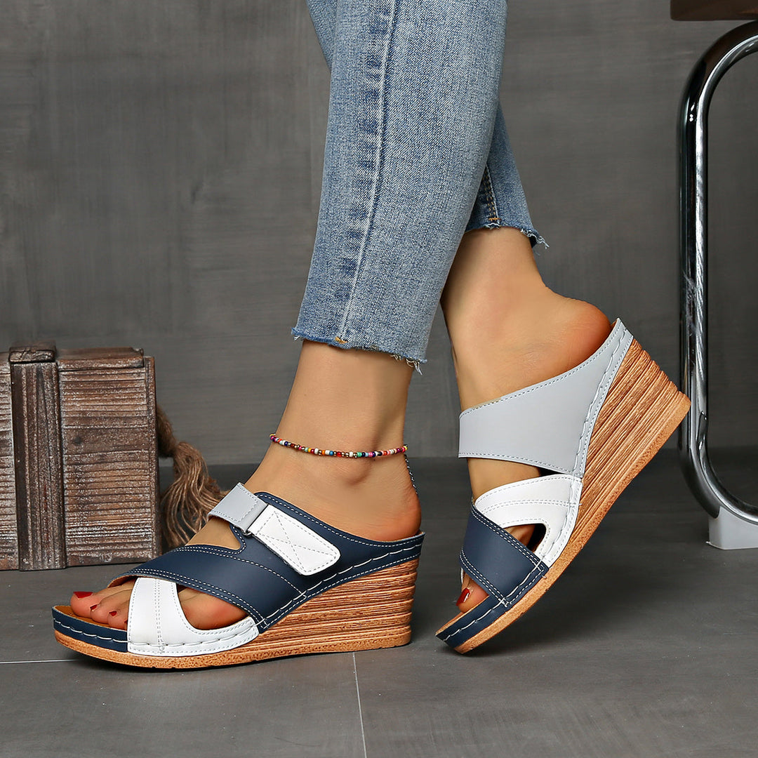 Modern two-tone wedge summer slides for women. Casual, comfortable slip-on footwear with open toe.