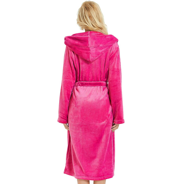 Women's cozy hooded bathrobe draped over a bed, showcasing its soft material and inviting comfort.