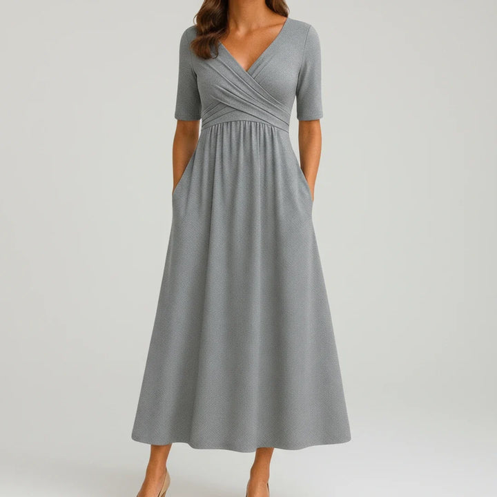 Women's V-neck A-line midi dress with convenient pockets, perfect for versatile everyday wear & spring fashion.