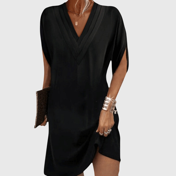 Women's V-neck mini dress, short sleeve, relaxed cocoon fit for casual summer style.