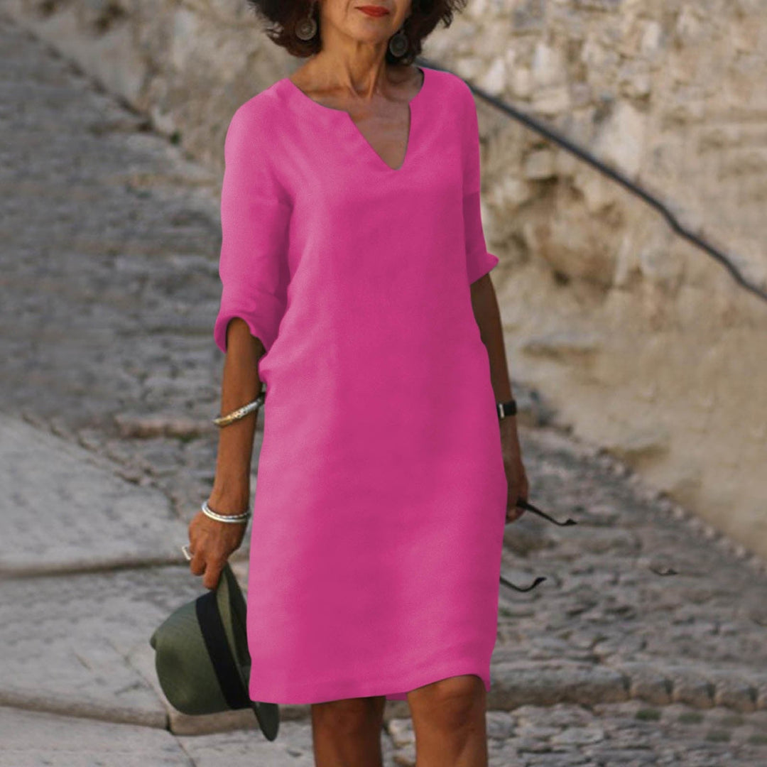 Chic women's V-neck relaxed fit summer midi dress in a vibrant color, ready for spring fashion.