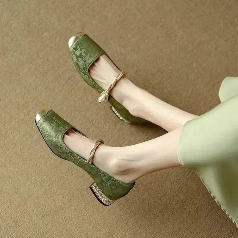 Side profile of Valoria women's elegant studded pumps, showcasing the chic square toe & stylish heel.