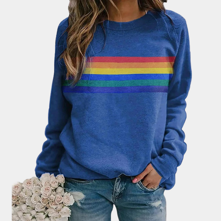 Women's vibrant rainbow stripe crewneck sweatshirt. Comfortable, colorful everyday relaxed fit sweater for casual style.
