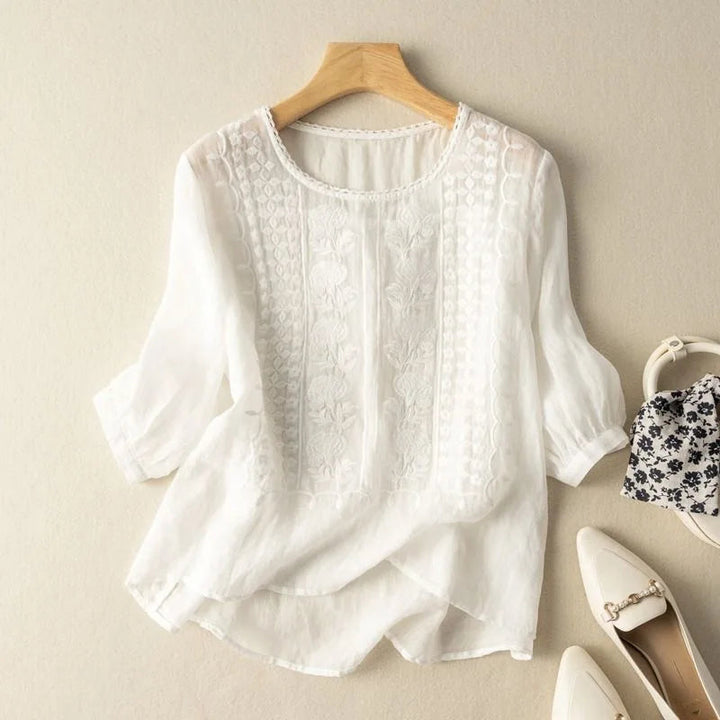 Women's vintage embroidered top styled casually, showcasing elegant puff sleeves, a chic and versatile spring blouse.