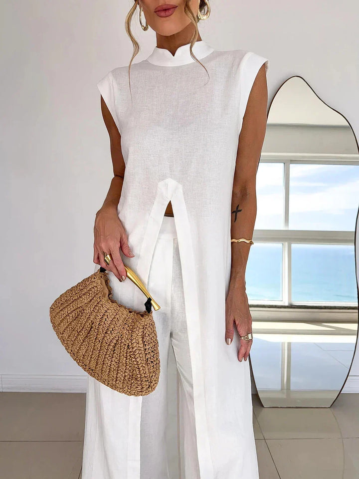 Stylish white women's two-piece resort wear: a loose tunic and elegant wide-leg pants for a chic boho summer look.
