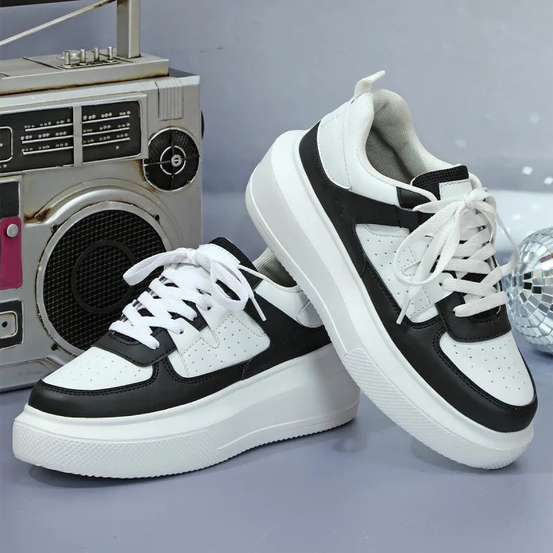 Fashionable women's perforated platform shoes, lace-up style, offering comfort and trendy appeal.