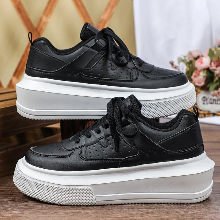 Stylish women's platform sneakers with intricate perforations and practical lace-up closure for fashion footwear.