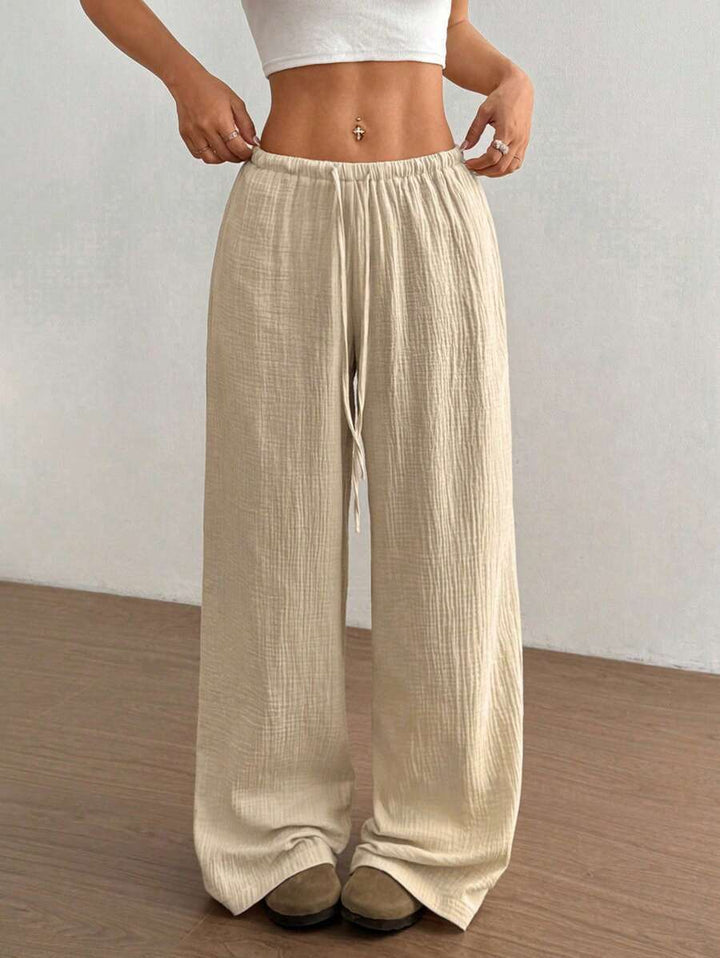 Trendy women's wide leg apparel: crinkle texture pants with a comfortable drawstring and elastic waist.