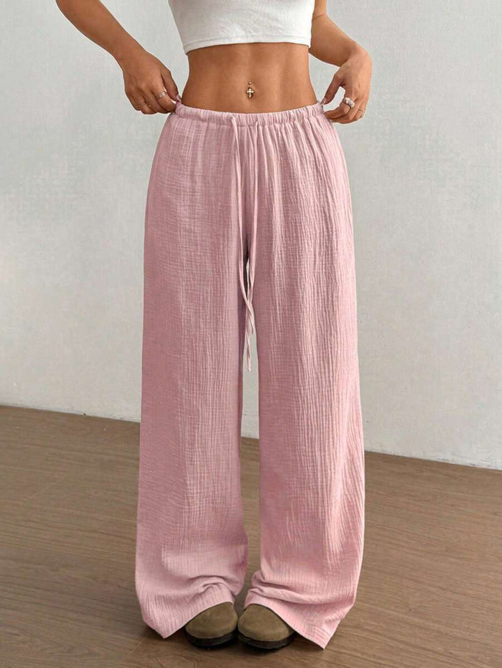 Close-up of crinkle texture on women's wide leg pants with a comfortable drawstring elastic waist.