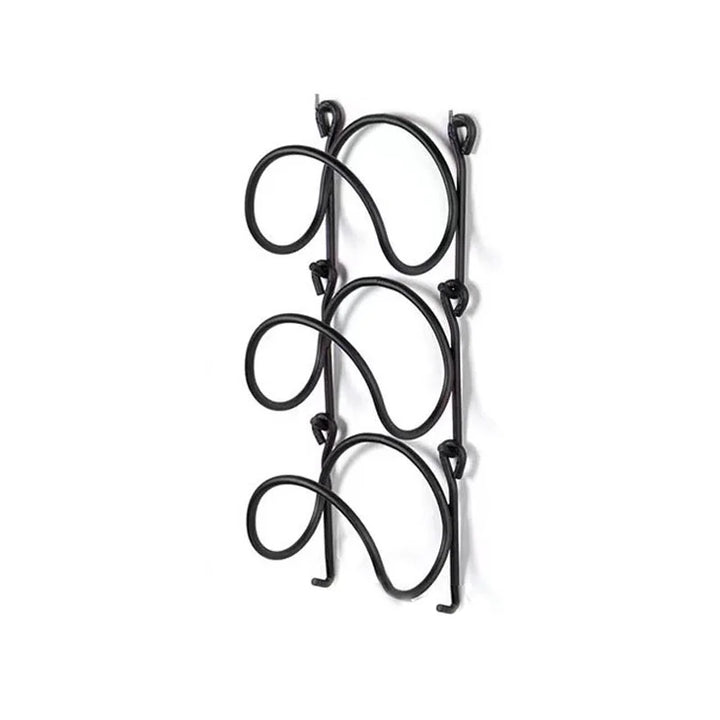 Elegant wrought iron multi-layer towel rack, ideal for a spa bathroom, enhancing wall decor & storage.